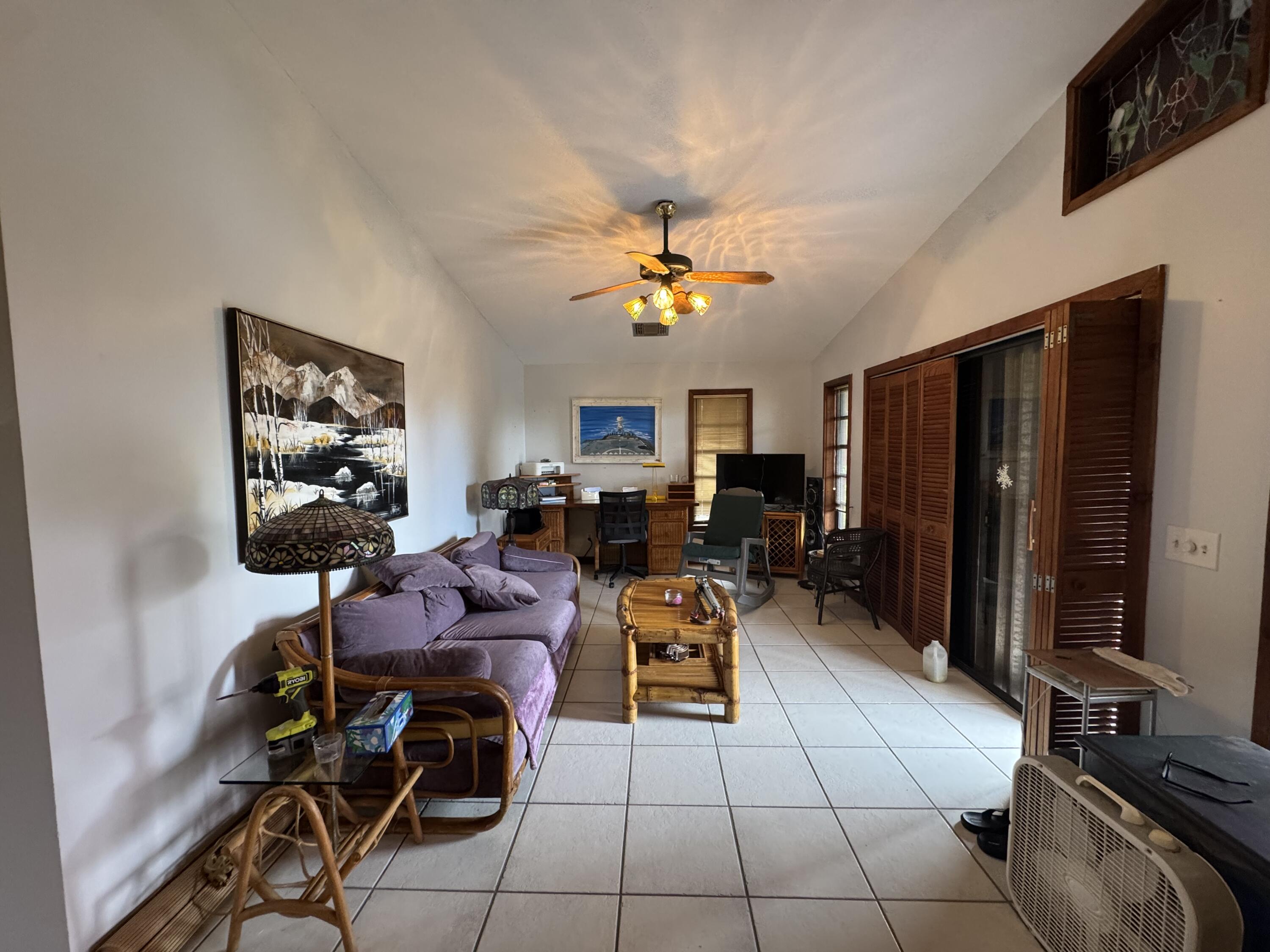 22970 Sharp Lane Cudjoe, FL 33042 - Photo 14 of 45 a living room with furniture a flat screen tv and a window