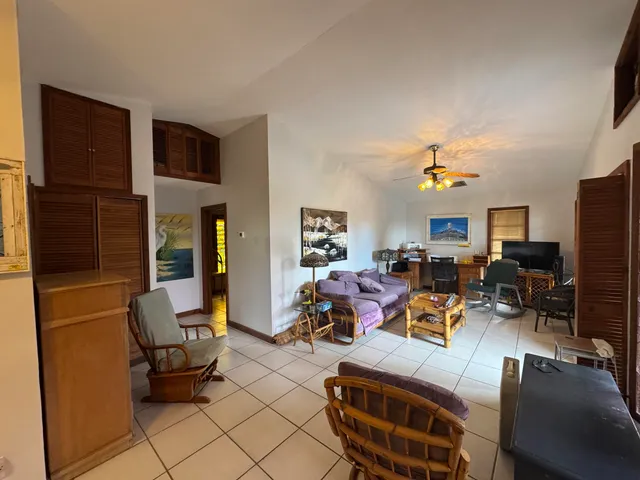 a living room with furniture a flat screen tv and a window