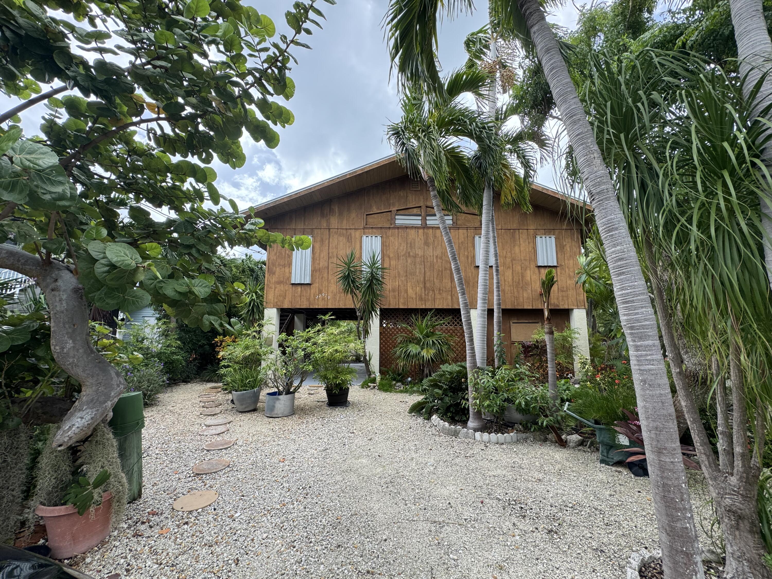 22970 Sharp Lane Cudjoe, FL 33042 - Photo 2 of 45 a front view of a house with a tree