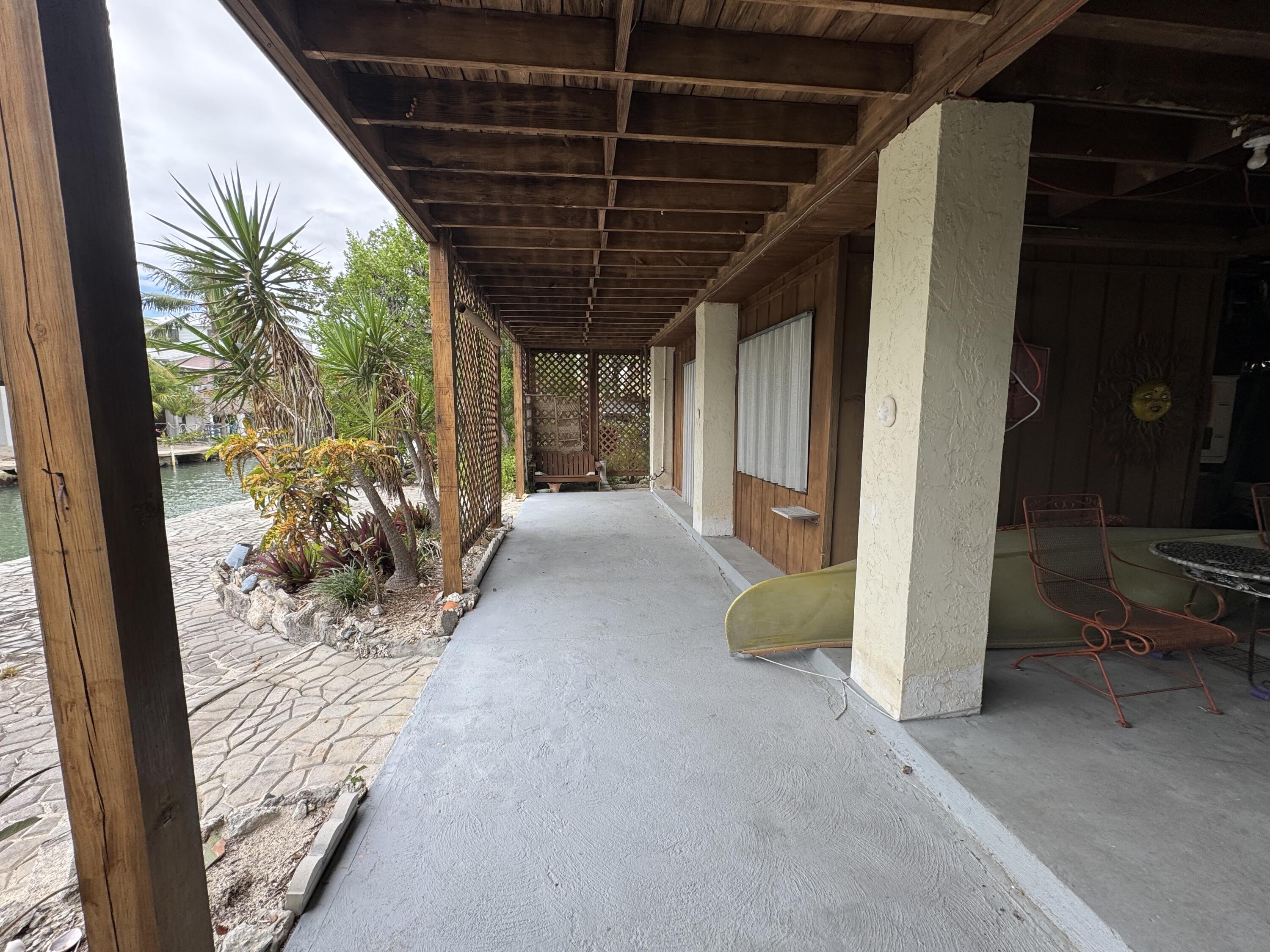 22970 Sharp Lane Cudjoe, FL 33042 - Photo 22 of 45 a view of a porch with table and chairs