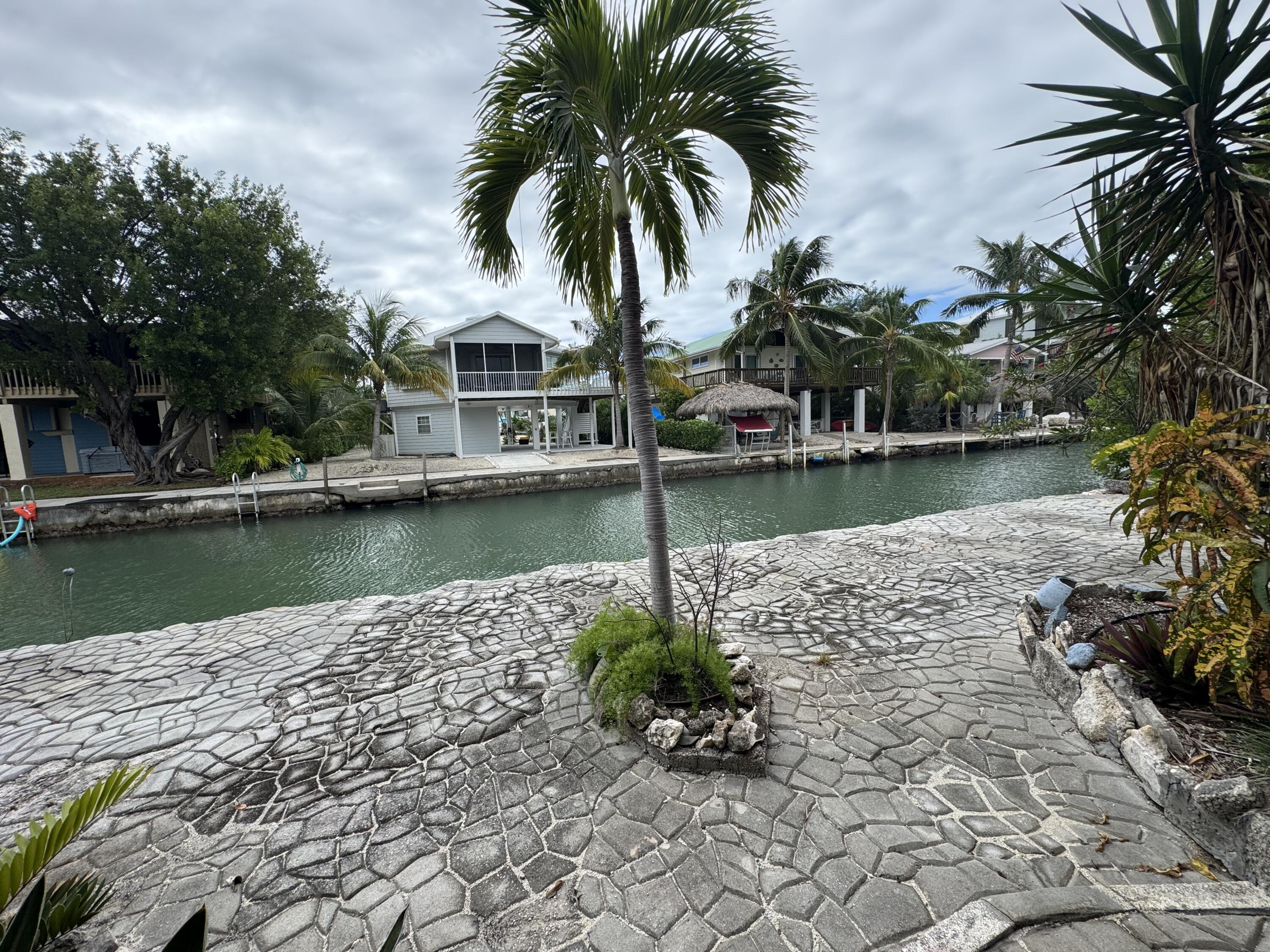 22970 Sharp Lane Cudjoe, FL 33042 - Photo 23 of 45 a view of a lake with a house