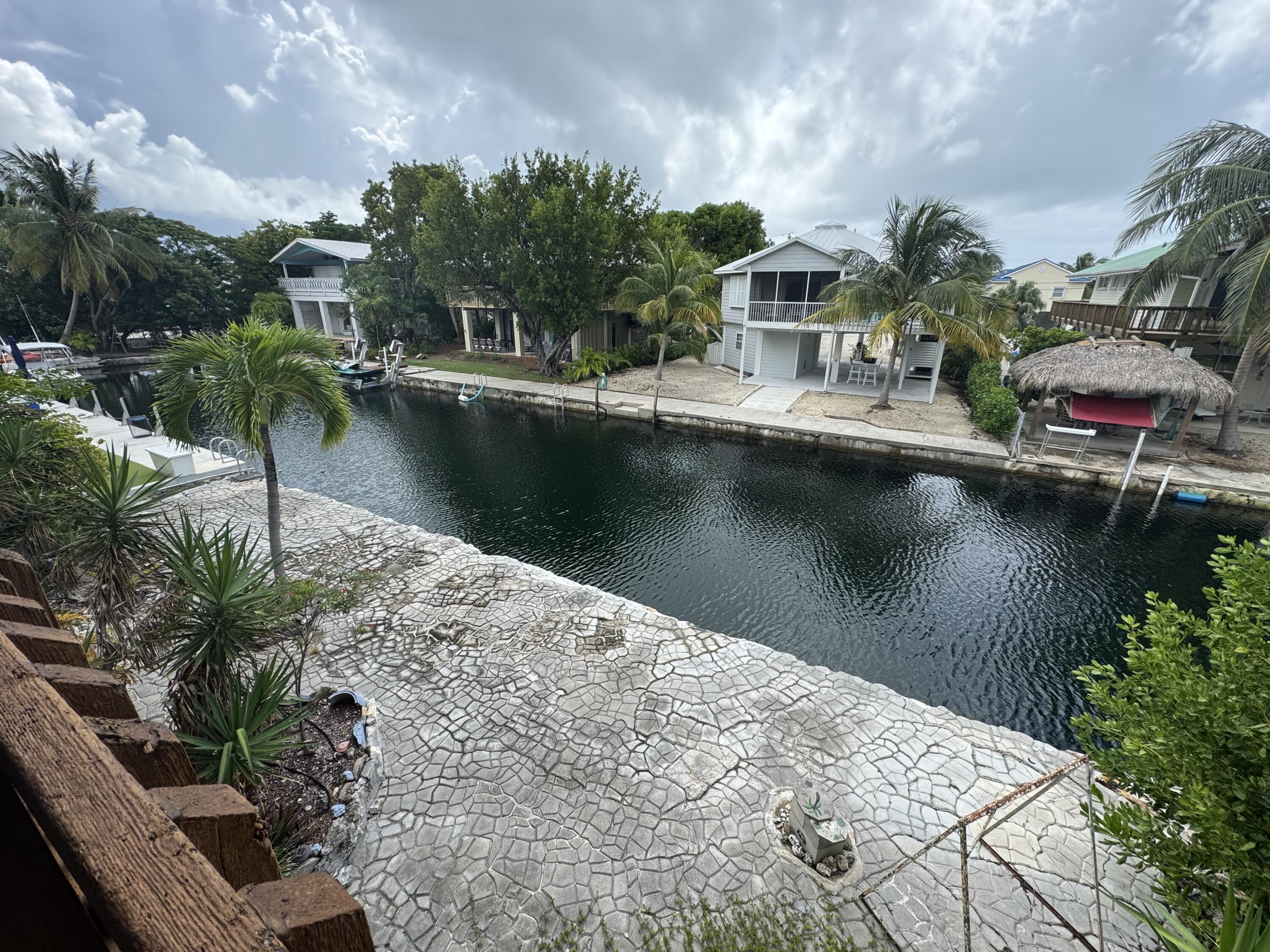 22970 Sharp Lane Cudjoe, FL 33042 - Photo 26 of 45 a view of a lake with a house