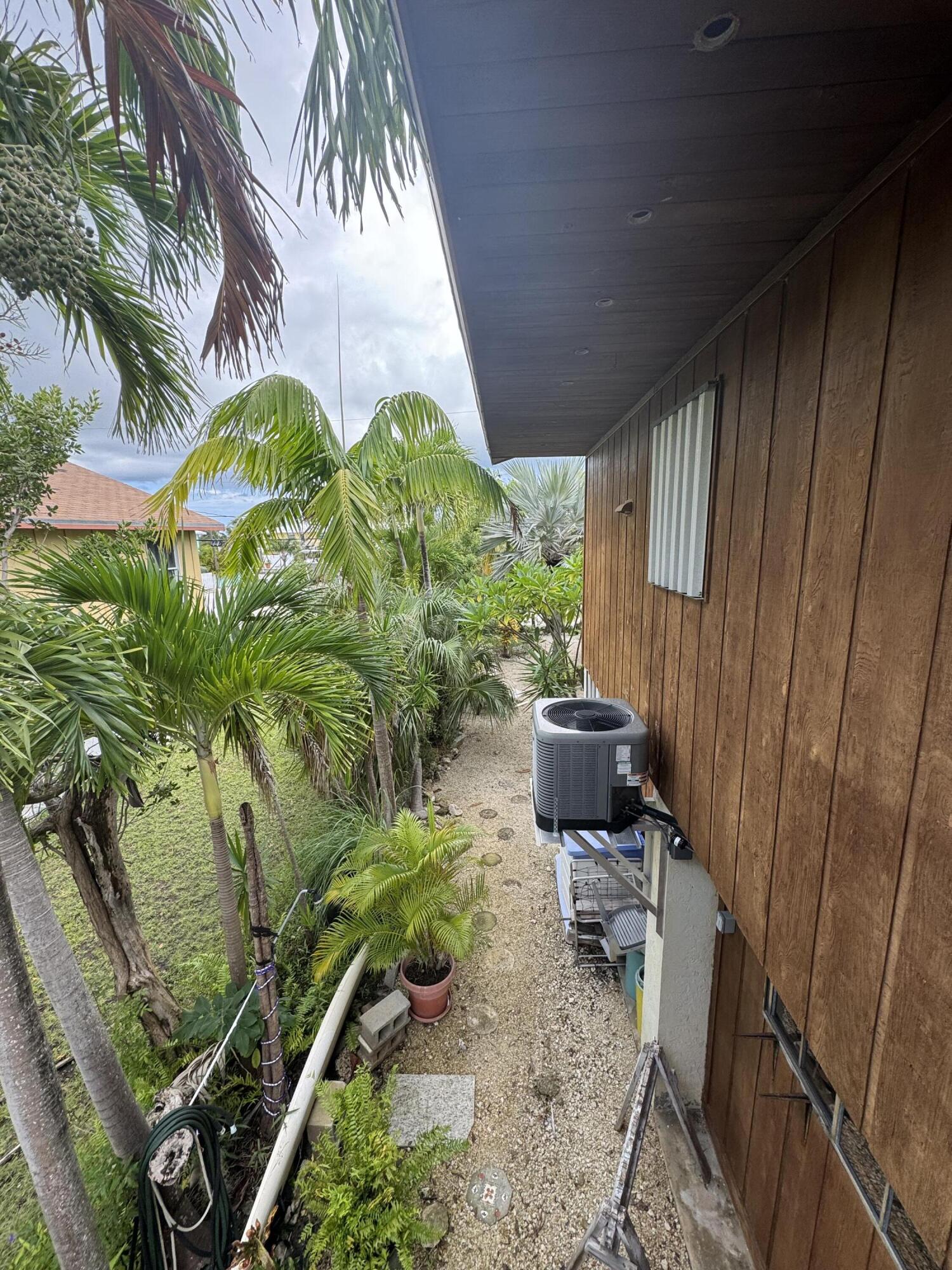 22970 Sharp Lane Cudjoe, FL 33042 - Photo 28 of 45 a backyard of a house with outdoor seating