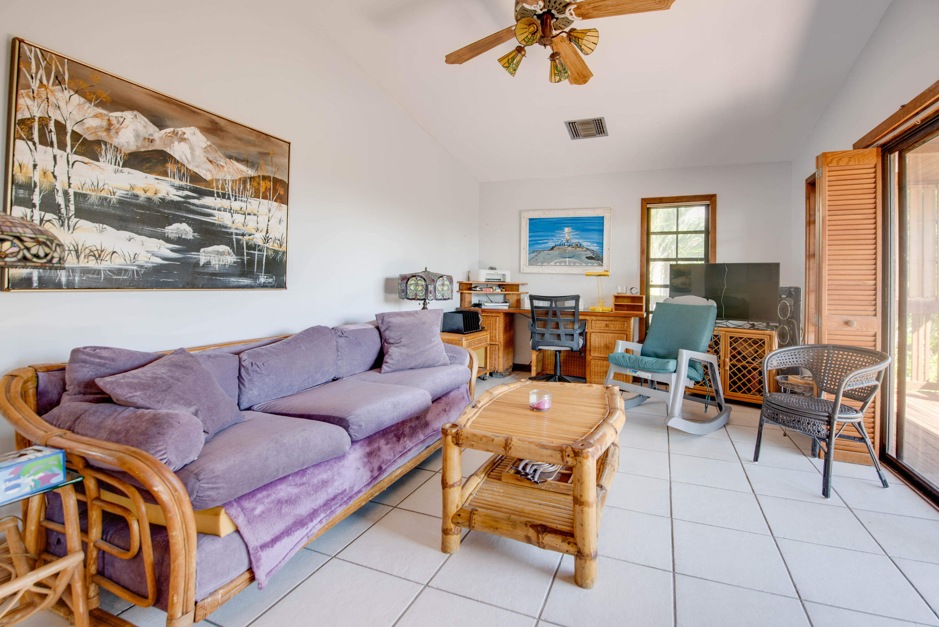 22970 Sharp Lane Cudjoe, FL 33042 - Photo 35 of 45 a living room with furniture a flat screen tv and a wall paintings