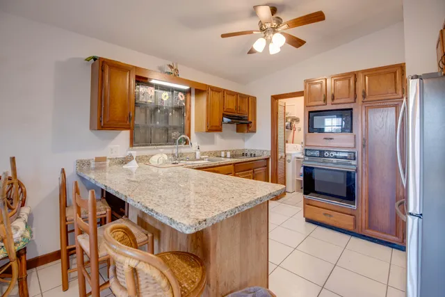 a kitchen with a stove a sink and a refrigerator