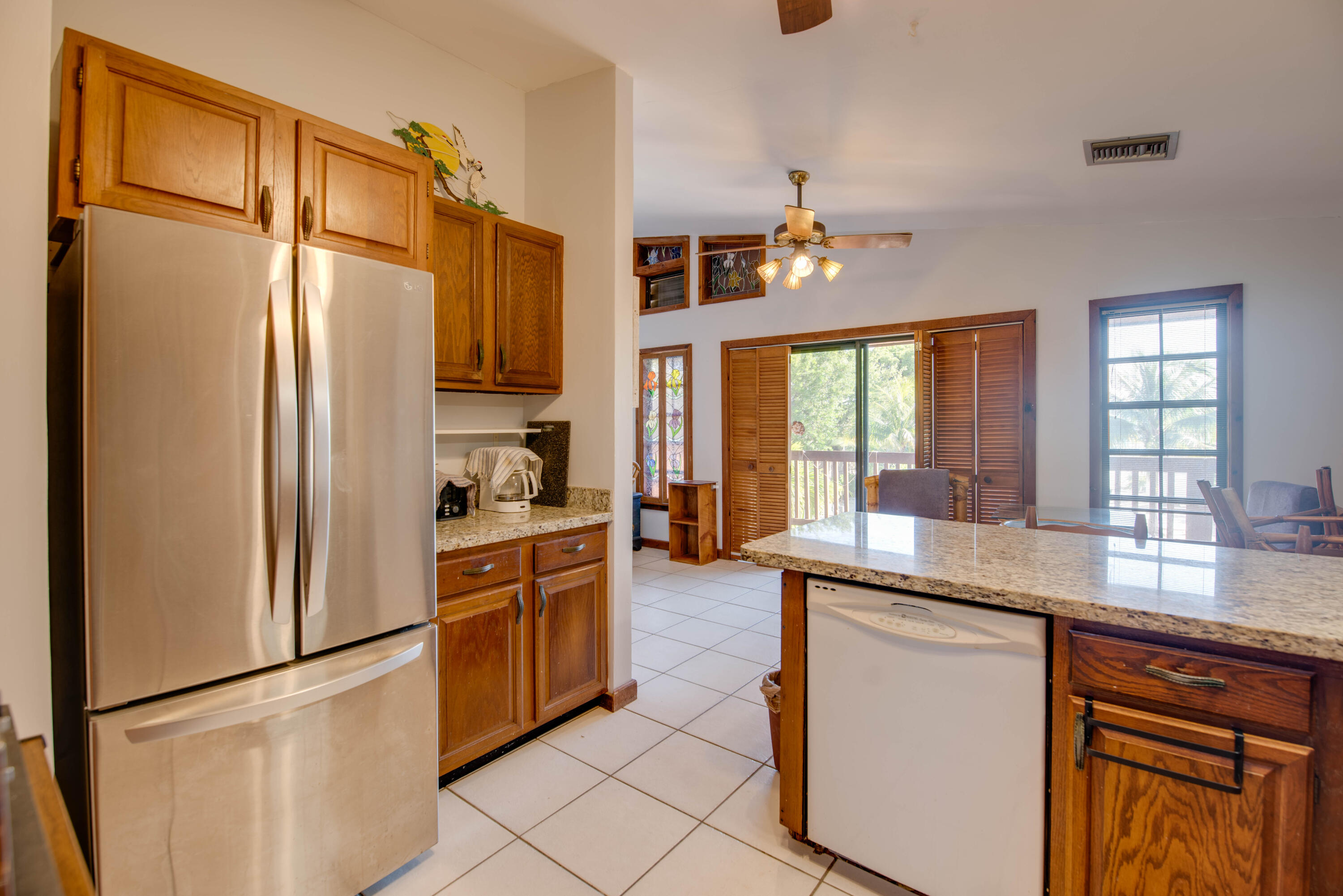 22970 Sharp Lane Cudjoe, FL 33042 - Photo 40 of 45 a kitchen with stainless steel appliances granite countertop a refrigerator and a sink