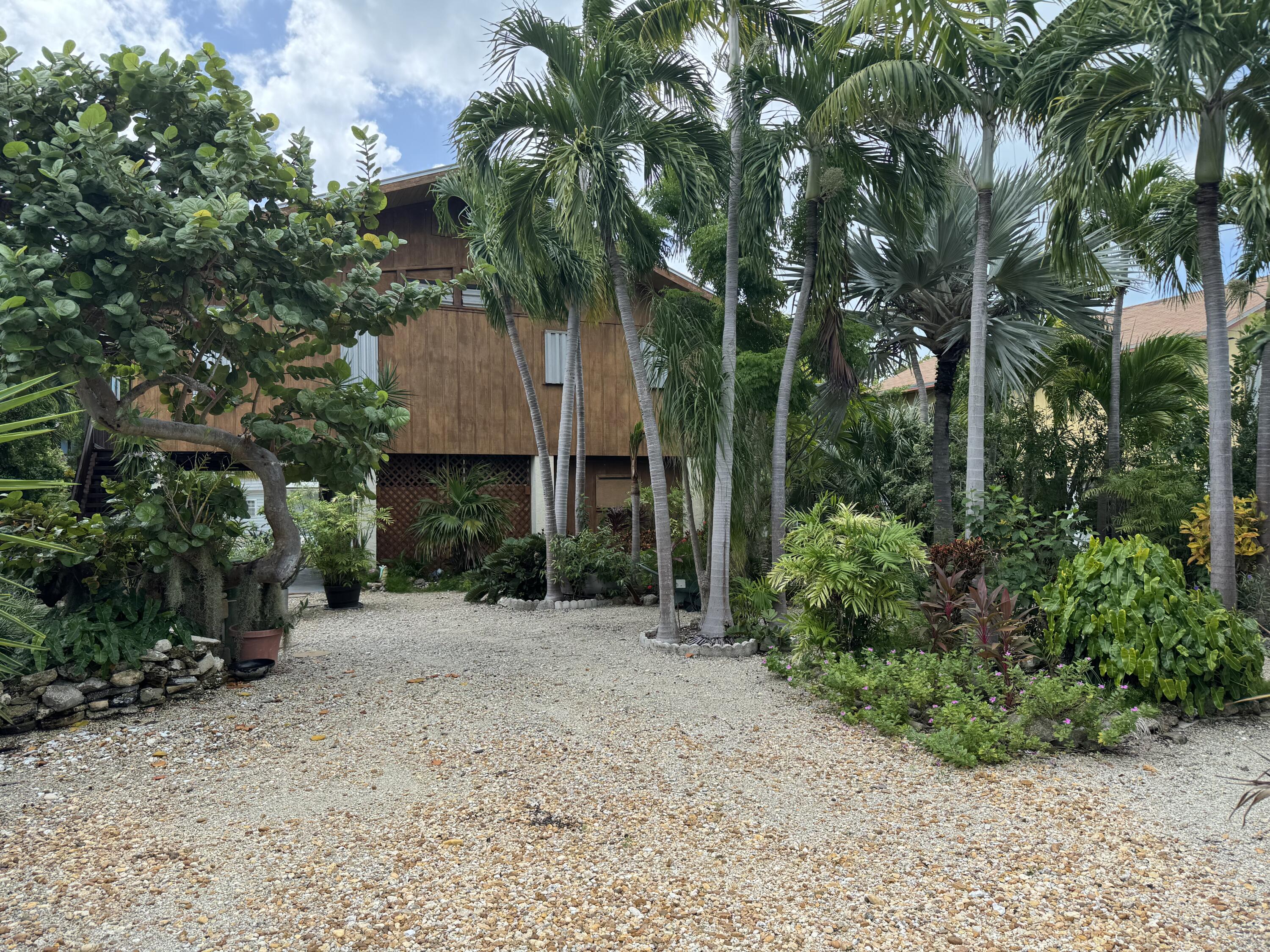 22970 Sharp Lane Cudjoe, FL 33042 - Photo 4 of 45 a front view of a house with a yard