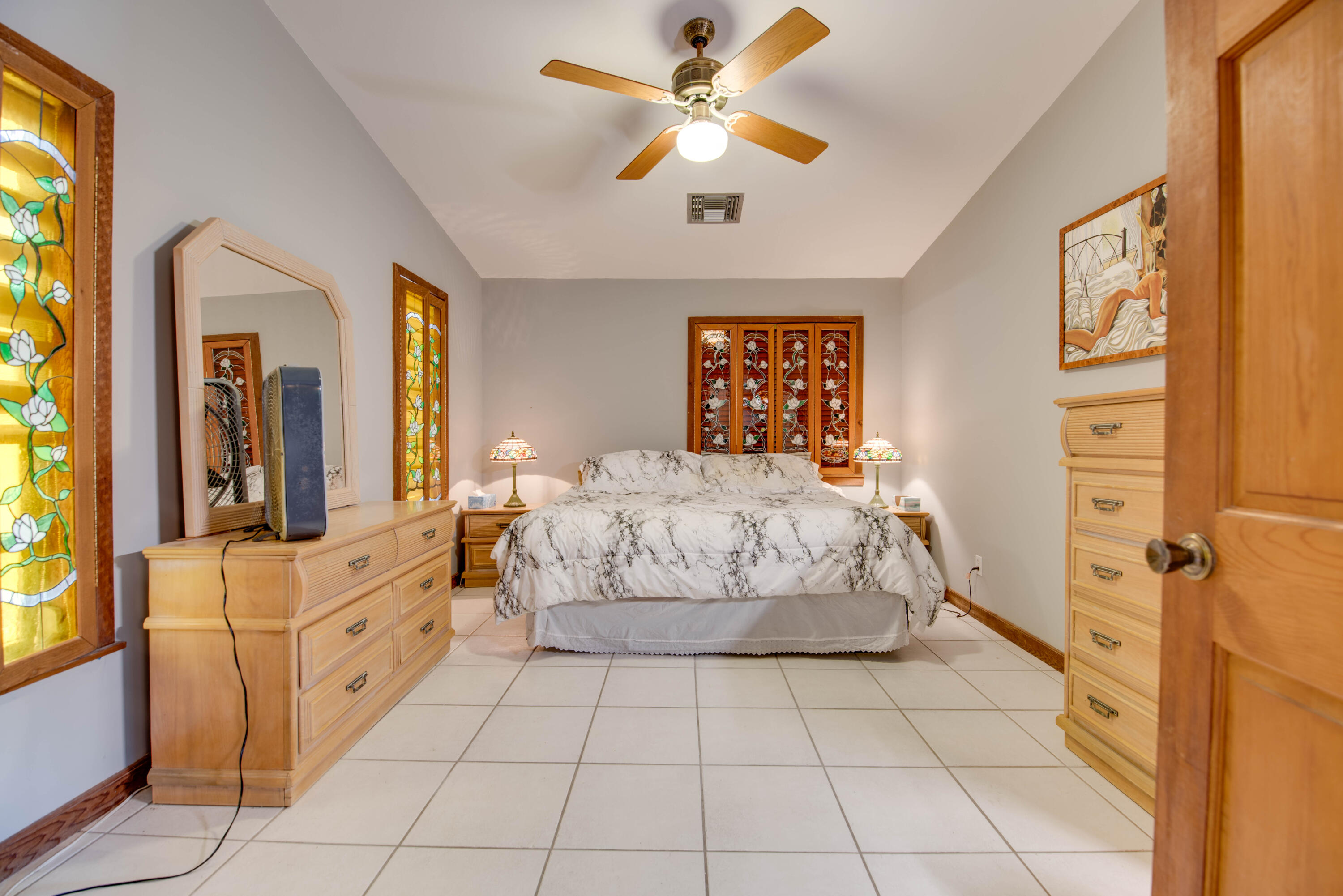 22970 Sharp Lane Cudjoe, FL 33042 - Photo 43 of 45 a bedroom with a bed and a chandelier