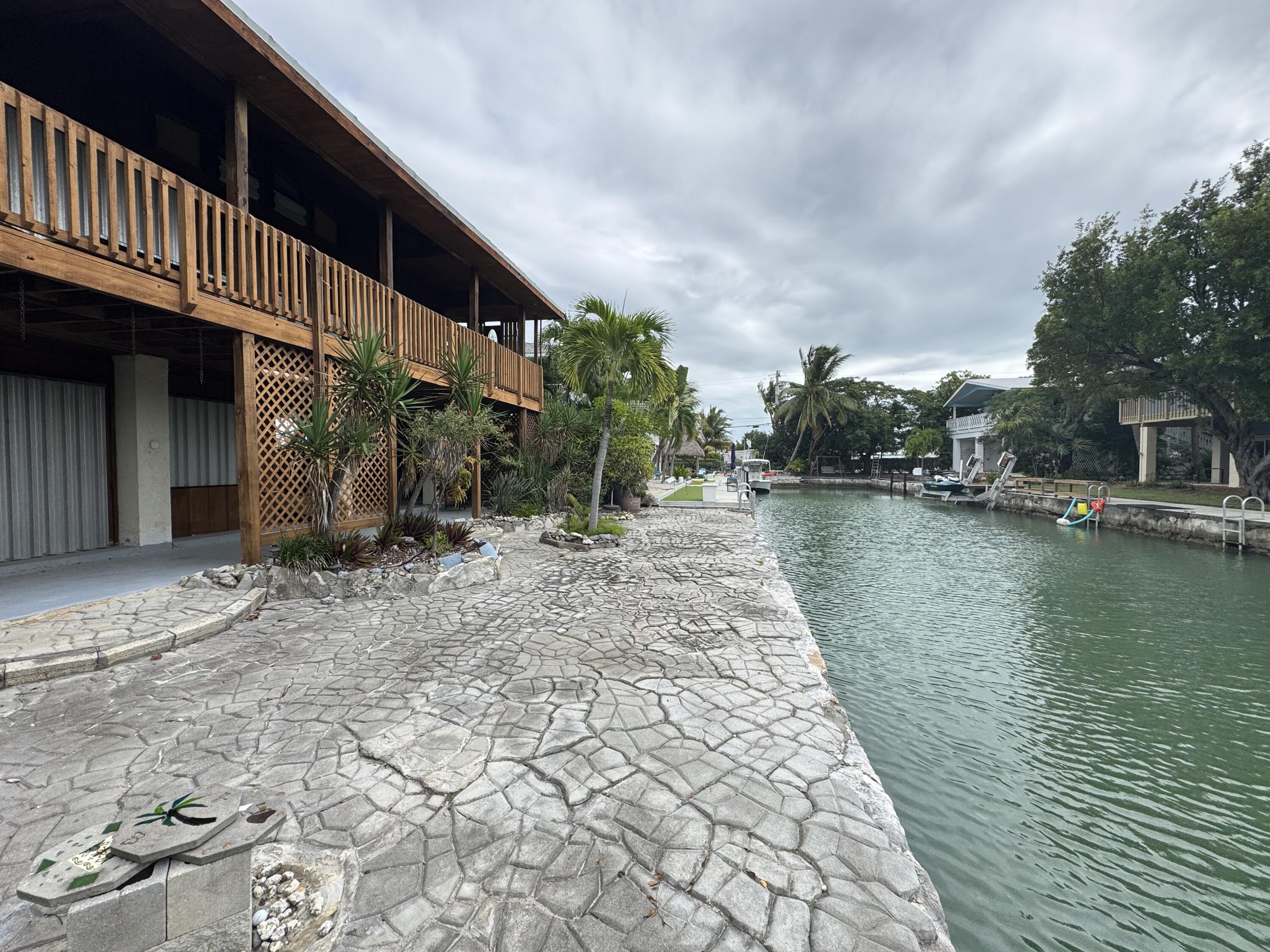 22970 Sharp Lane Cudjoe, FL 33042 - Photo 7 of 45 a backyard of a house with lots of green space