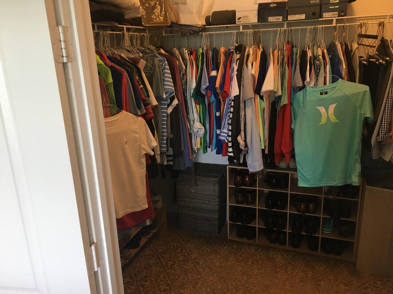 555 Northwest 35th Place Boca Raton, FL 33431 - Photo 32 of 43 a view of walk in closet with clothes and shoes