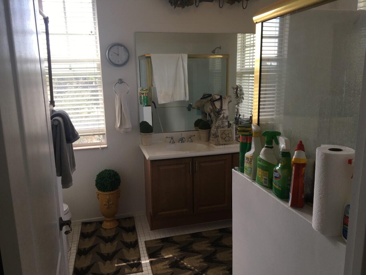 555 Northwest 35th Place Boca Raton, FL 33431 - Photo 33 of 43 a bathroom with a sink a toilet and mirror