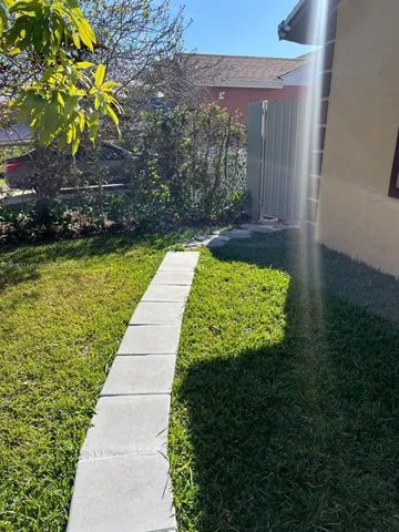 a view of swimming pool with a yard