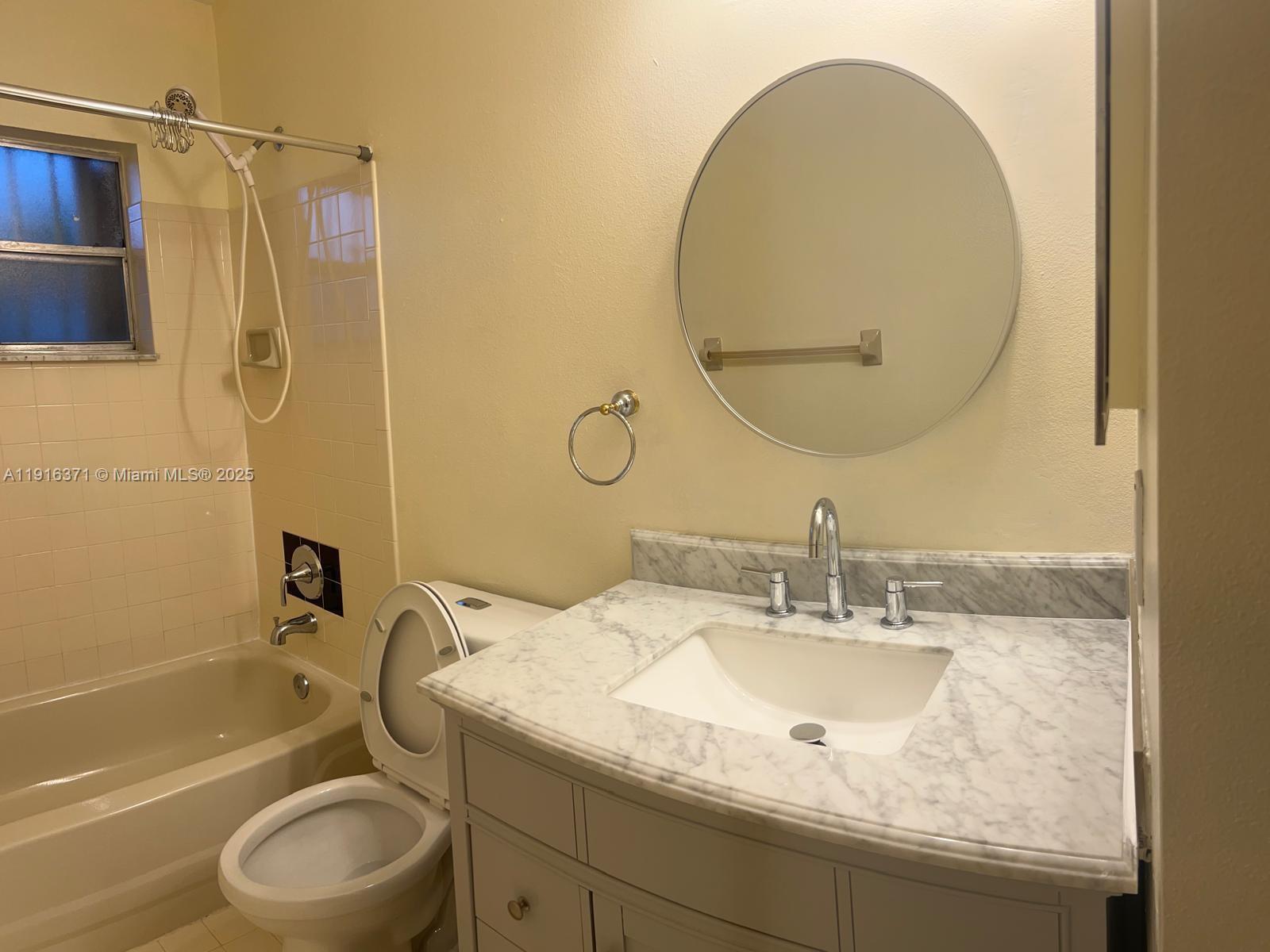 26636 Southwest 126th Avenue Homestead, FL 33032 - Photo 12 of 14 a bathroom with a granite countertop sink toilet and a mirror