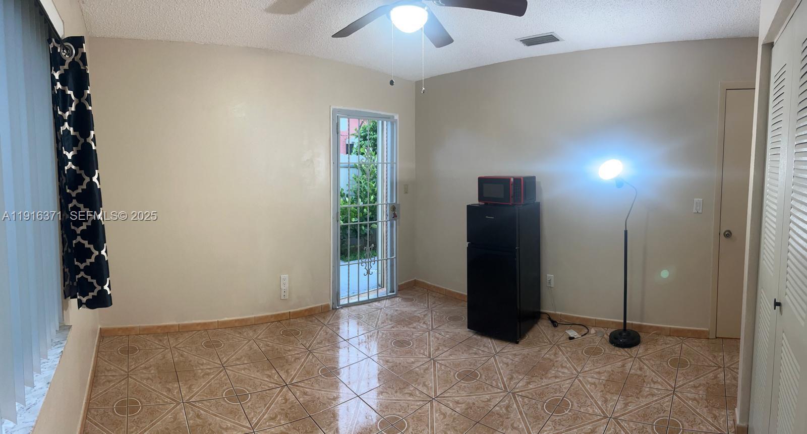 26636 Southwest 126th Avenue Homestead, FL 33032 - Photo 4 of 14 an empty room with windows
