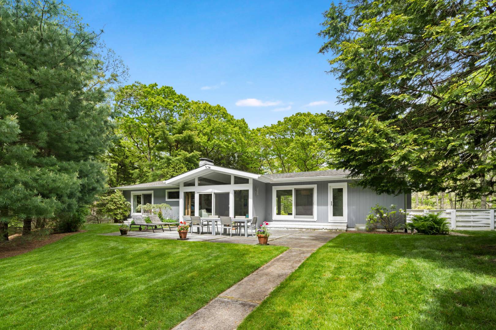 218 Bull Path East Hampton, NY 11937 - Photo 1 of 20 a view of house with a big yard and large trees