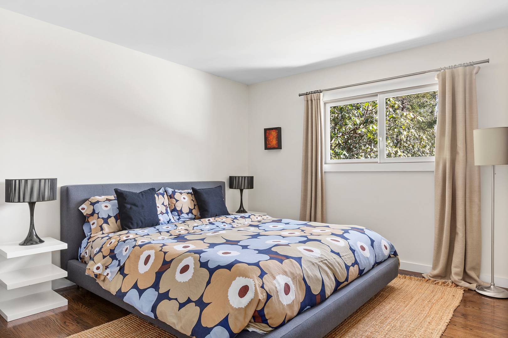 218 Bull Path East Hampton, NY 11937 - Photo 15 of 20 a large bed sitting in a bedroom next to a window