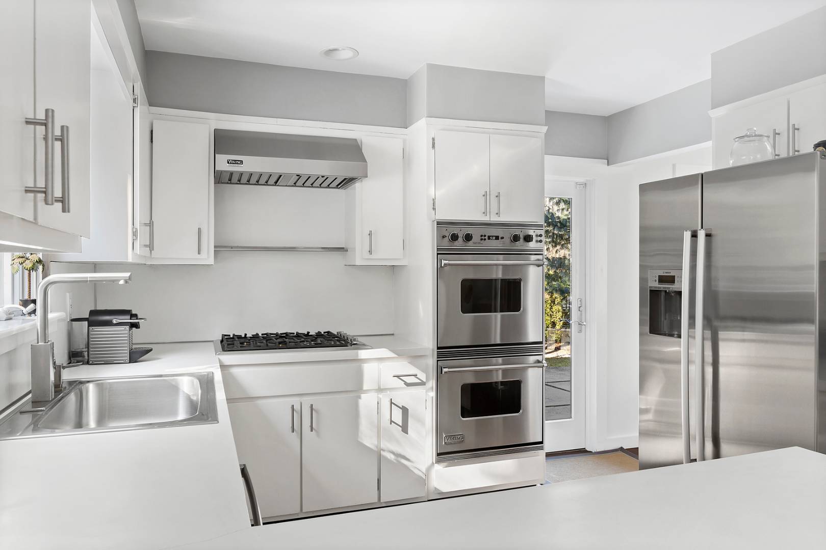 218 Bull Path East Hampton, NY 11937 - Photo 9 of 20 a kitchen with cabinets and stainless steel appliances