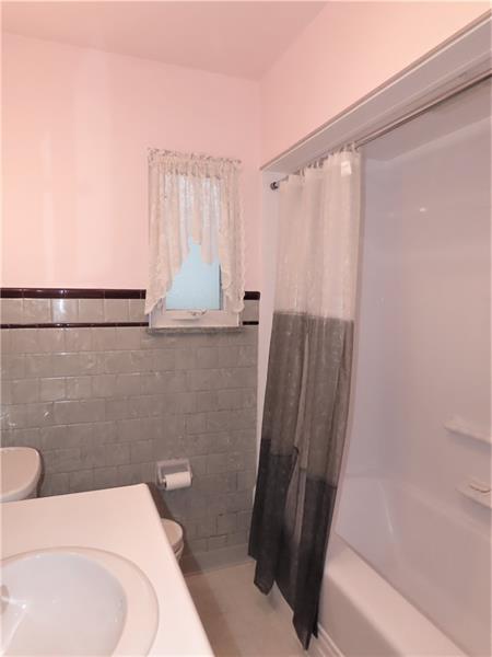 675 Davidson Drive Rochester, PA 15074 - Photo 12 of 25 Full main bath with "Bathfitters" tub surround, neutral fixtures and linen closet
