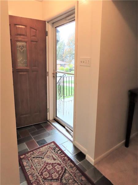 675 Davidson Drive Rochester, PA 15074 - Photo 3 of 25 Inviting entry way with slate floor, glass storm door, and two closets! Connects to hallway to the bedrooms, bath, and kitchen area