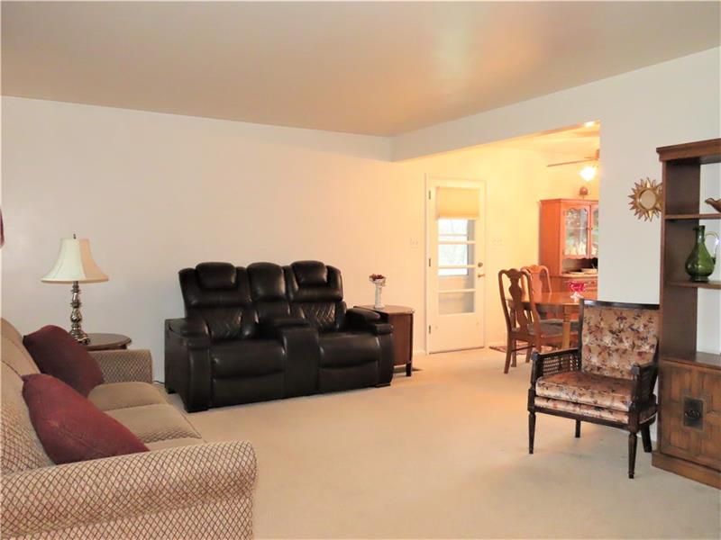 675 Davidson Drive Rochester, PA 15074 - Photo 4 of 25 Spacious living room with large picture window, and opens to the dining room. Door leads to covered patio.