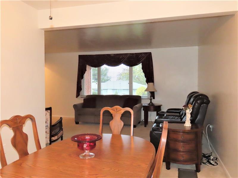 675 Davidson Drive Rochester, PA 15074 - Photo 6 of 25 Dining room opens to the living room area. Door to side covered patio and doorway to kitchen area.