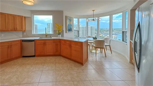 a kitchen with stainless steel appliances granite countertop a refrigerator and a sink