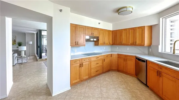 a kitchen with granite countertop a sink cabinets and window