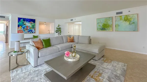 a living room with furniture and a large window