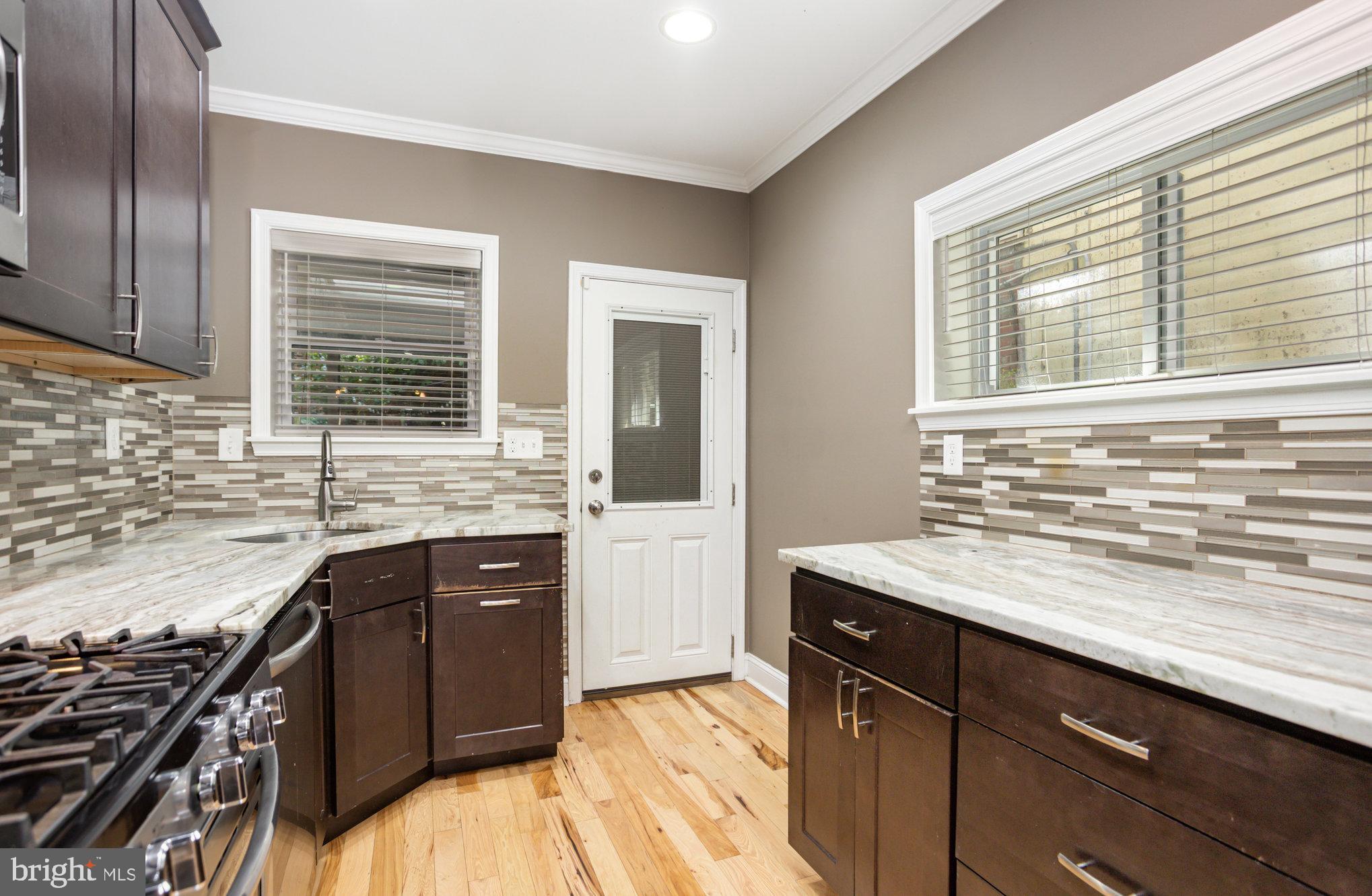 3515 Gough Street Baltimore, MD 21224 - Photo 11 of 27 a kitchen with a sink stove and cabinets