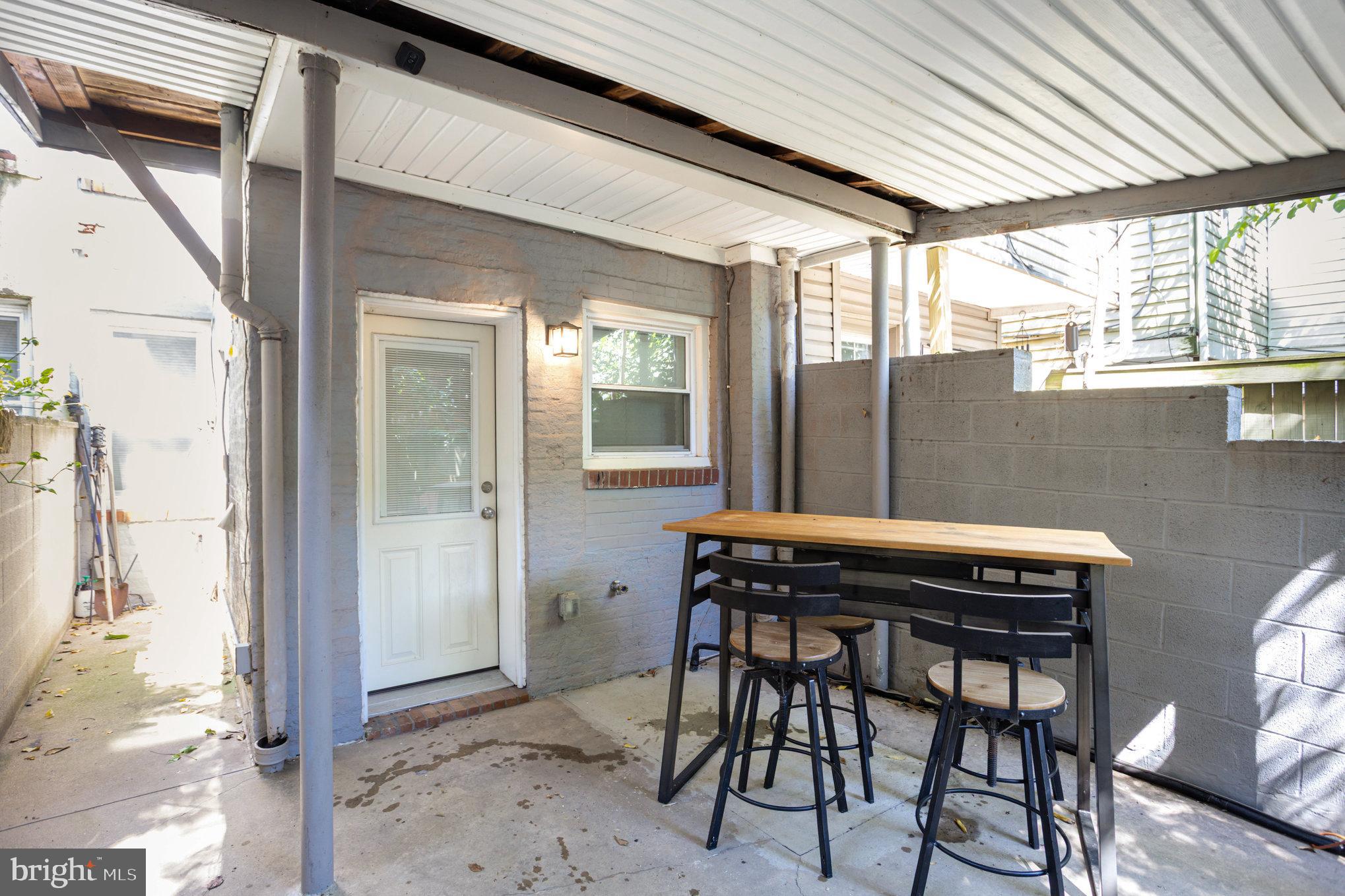3515 Gough Street Baltimore, MD 21224 - Photo 24 of 27 a table and chairs in front of a house