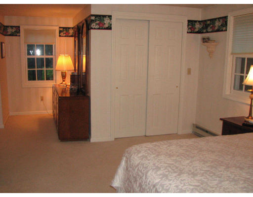292 Cedar Street Sturbridge, MA 01518 - Photo 9 of 20 a bedroom with a bed and cabinets