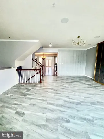 a view of a room with wooden floor