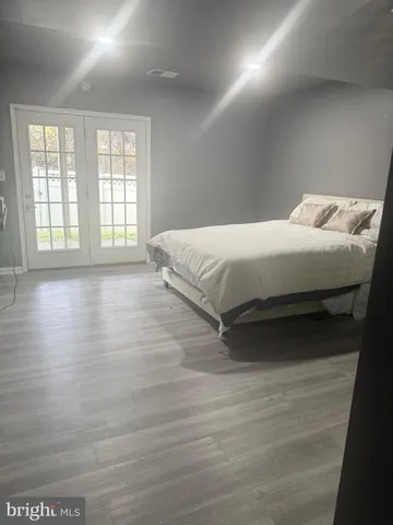 a large bed sitting in a bedroom next to a window