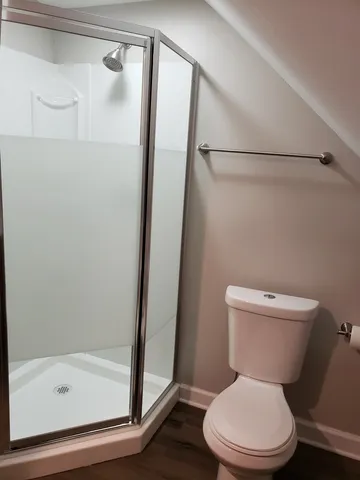 a white toilet sitting next to a bath tub