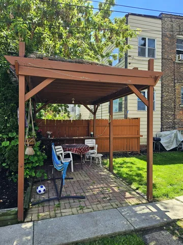 a view of a deck with a table and chairs under an umbrella