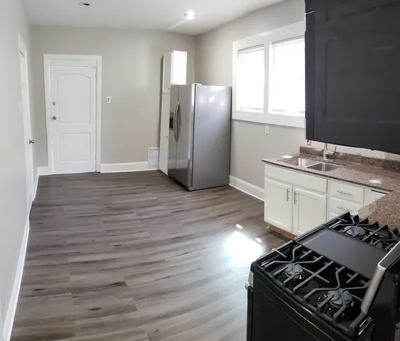 a kitchen with stainless steel appliances granite countertop a stove and a refrigerator