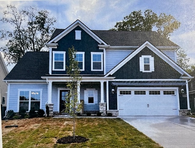 a front view of a house with yard and parking space