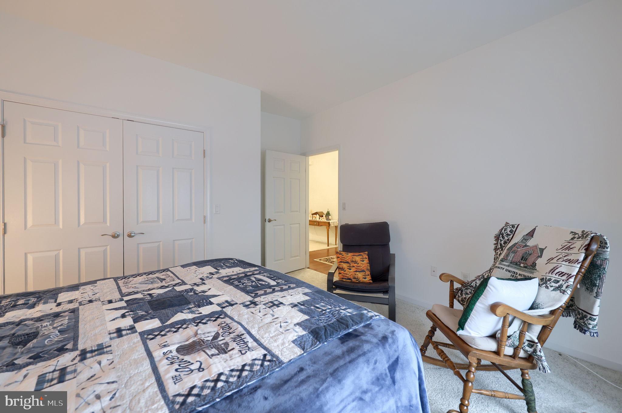 423 Valor Drive Lititz, PA 17543 - Photo 22 of 29 a bedroom with a bed a chair and a chandelier