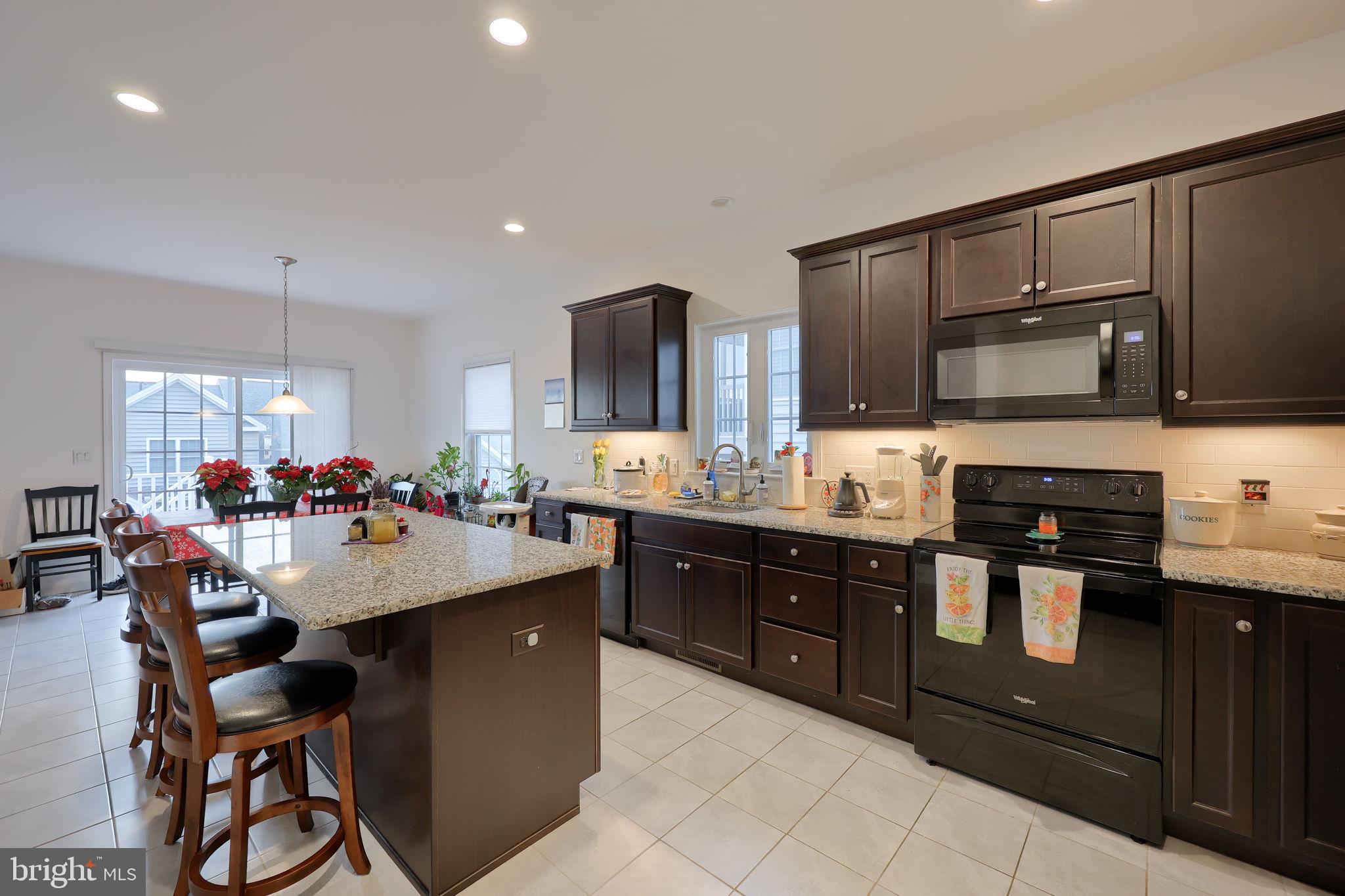 423 Valor Drive Lititz, PA 17543 - Photo 4 of 29 a kitchen with stainless steel appliances granite countertop a sink counter space and chairs