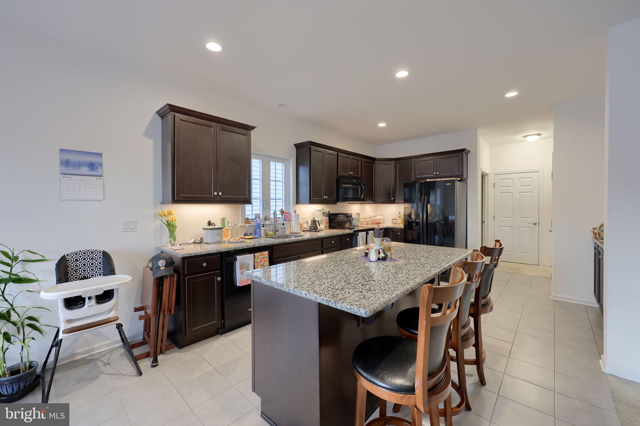 423 Valor Drive Lititz, PA 17543 - Photo 6 of 29 a kitchen with a dining table chairs and refrigerator