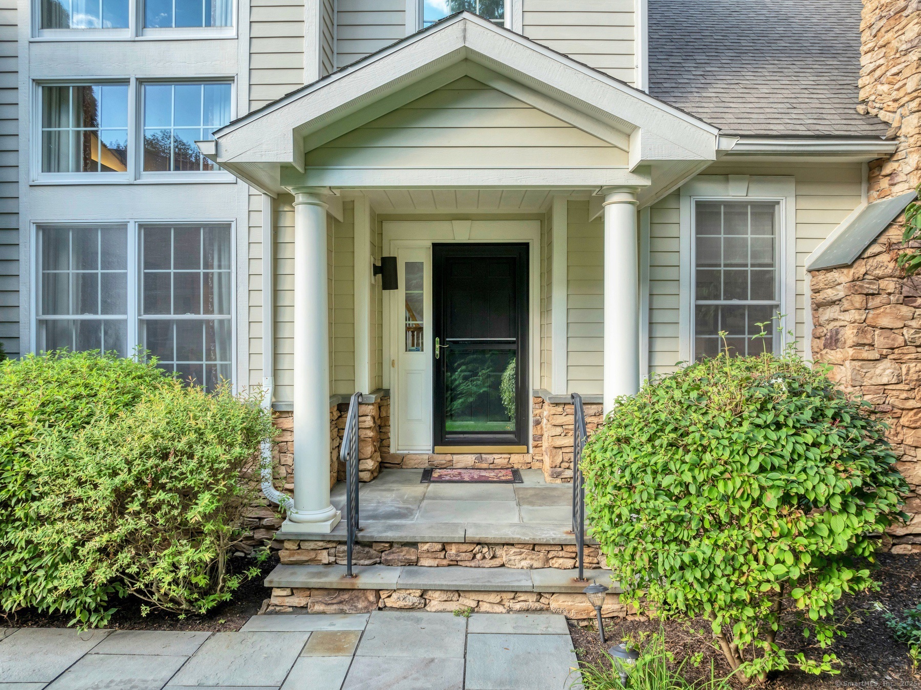 a front view of a house with garden