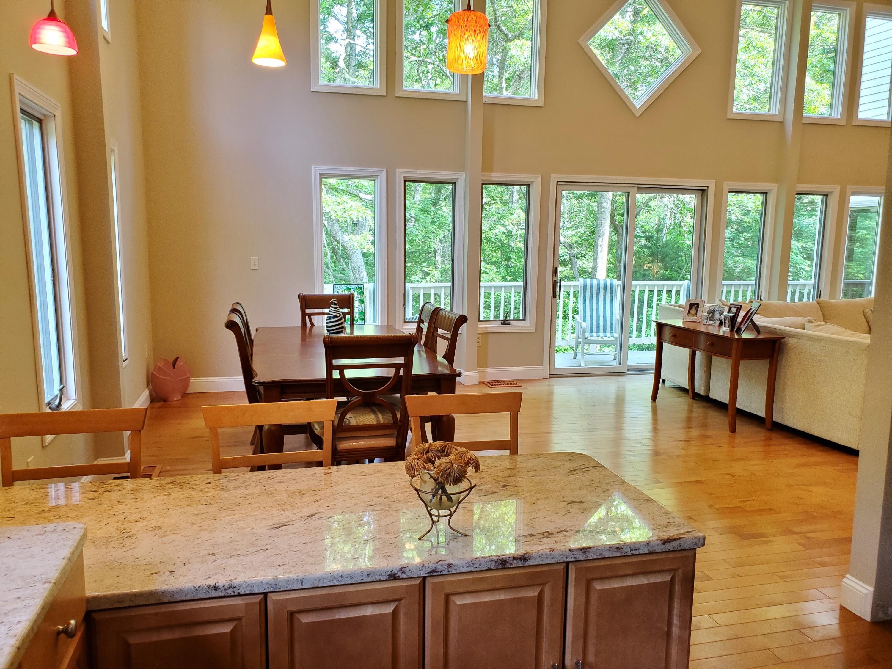 65 Pinecrest Road Centerville, MA 02632 - Photo 8 of 15 a view of a dining room with furniture a chandelier and wooden floor