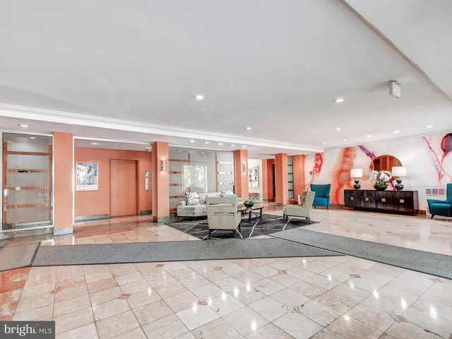 a living room with furniture and large windows