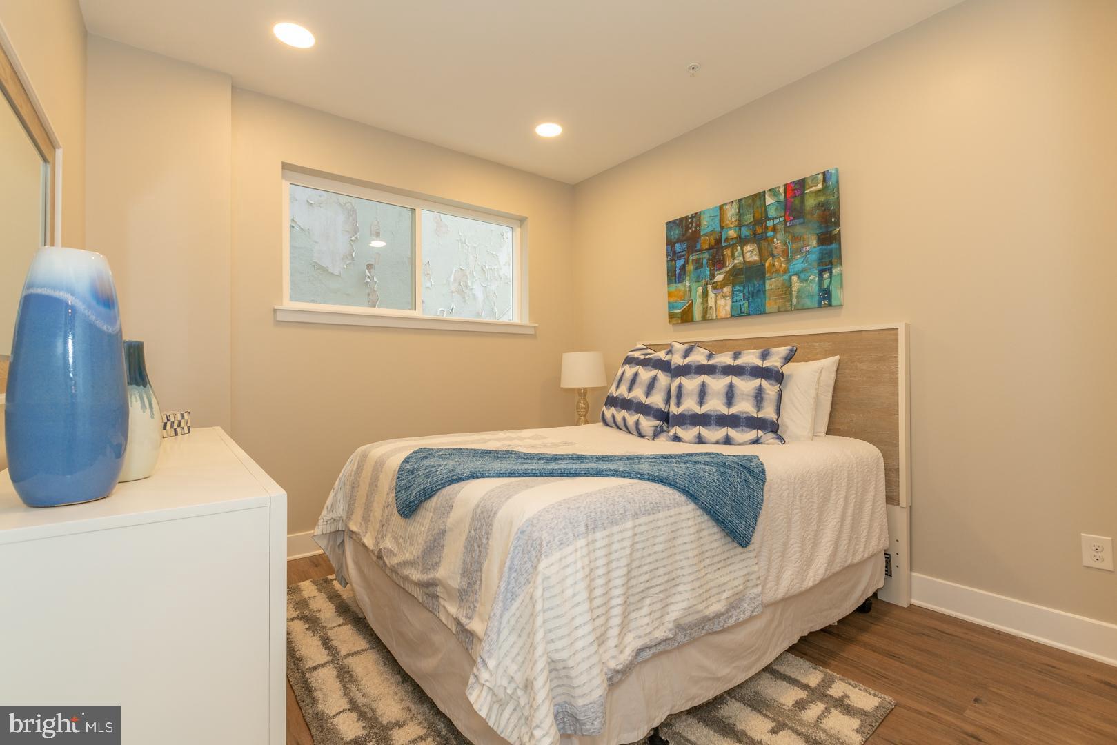 2220-28 Master Street, Unit 1 Philadelphia, PA 19121 - Photo 2 of 14 a bedroom with a bed and a window