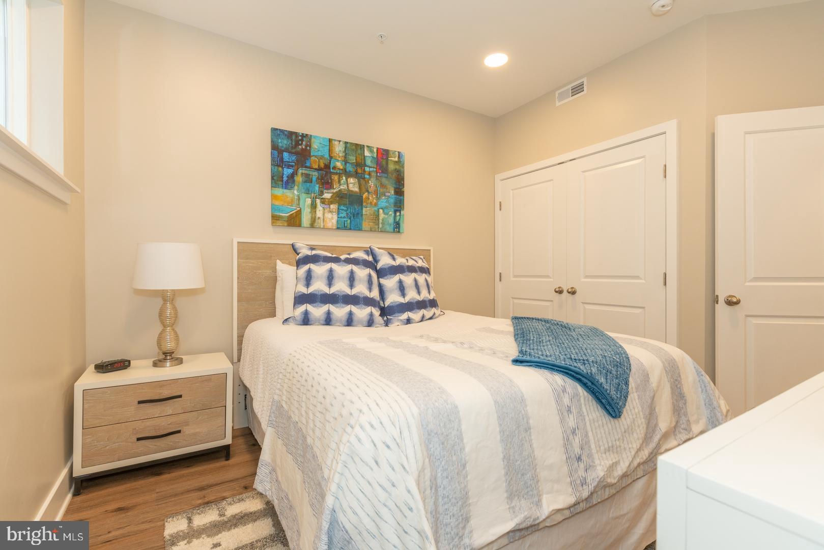 2220-28 Master Street, Unit 1 Philadelphia, PA 19121 - Photo 3 of 14 a bedroom with a bed and a night stand