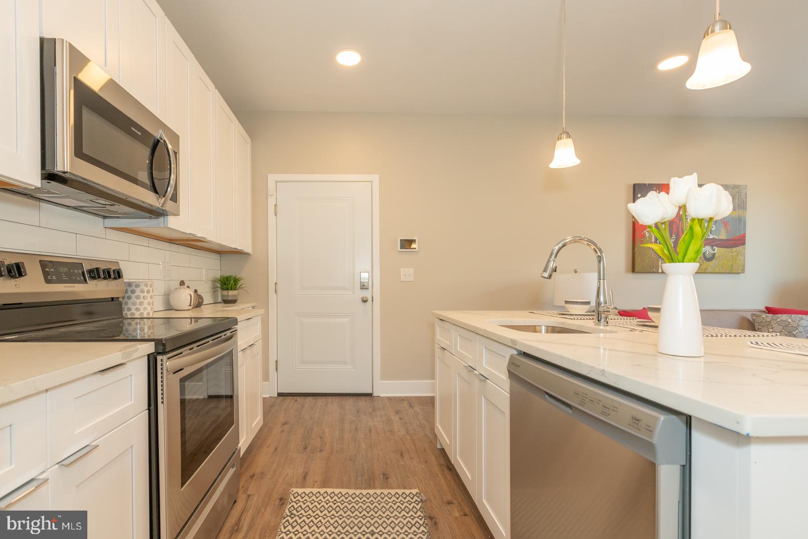 2220-28 Master Street, Unit 1 Philadelphia, PA 19121 - Photo 9 of 14 a kitchen with a sink stove and microwave