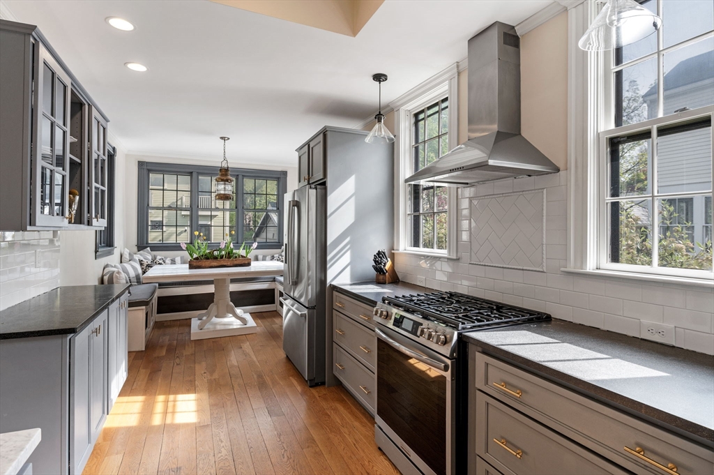31 Broad Street Salem, MA 01970 - Photo 18 of 39 a kitchen with stainless steel appliances granite countertop a stove and a wooden floors