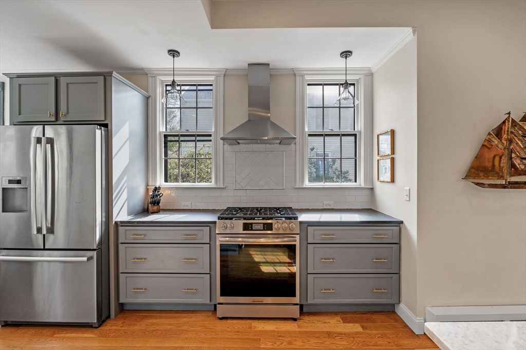 31 Broad Street Salem, MA 01970 - Photo 19 of 39 a kitchen with stainless steel appliances granite countertop a stove and a refrigerator