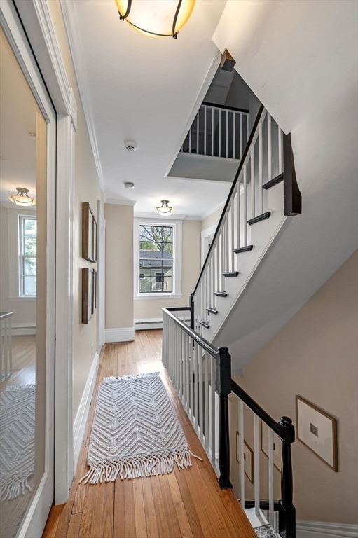 31 Broad Street Salem, MA 01970 - Photo 23 of 39 a view of staircase with wooden floor and white walls