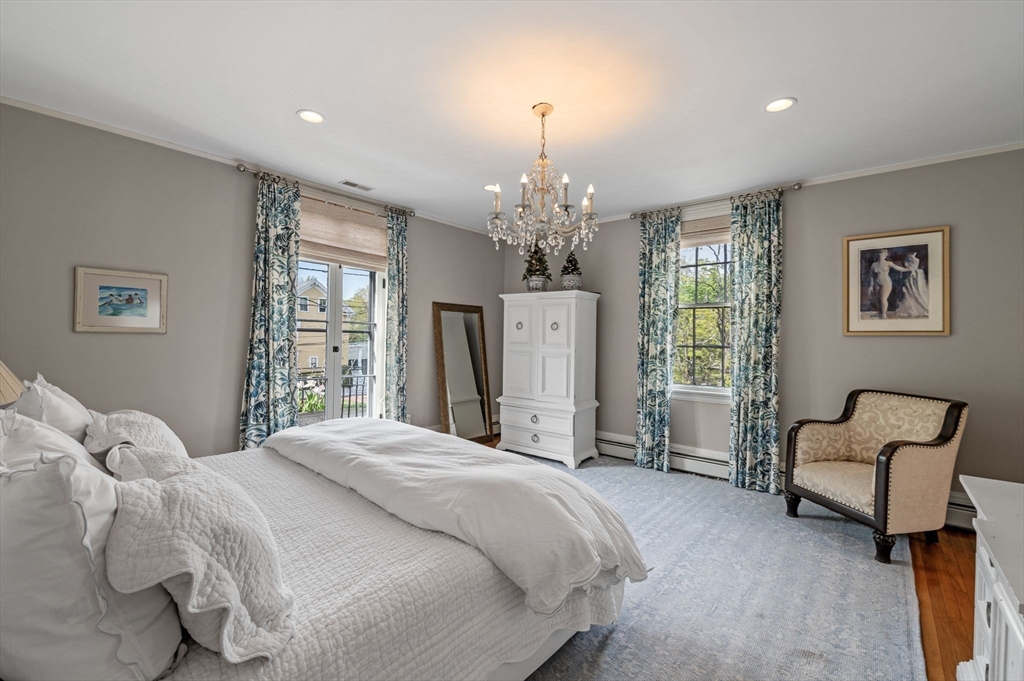 31 Broad Street Salem, MA 01970 - Photo 24 of 39 a spacious bedroom with a bed and a chandelier